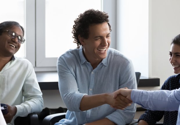 Cropped panoramic photo diverse business parties accomplish negotiations in office, finish successful group meeting shake hands feel satisfied by partnership, succeed goal, making profit deal concept